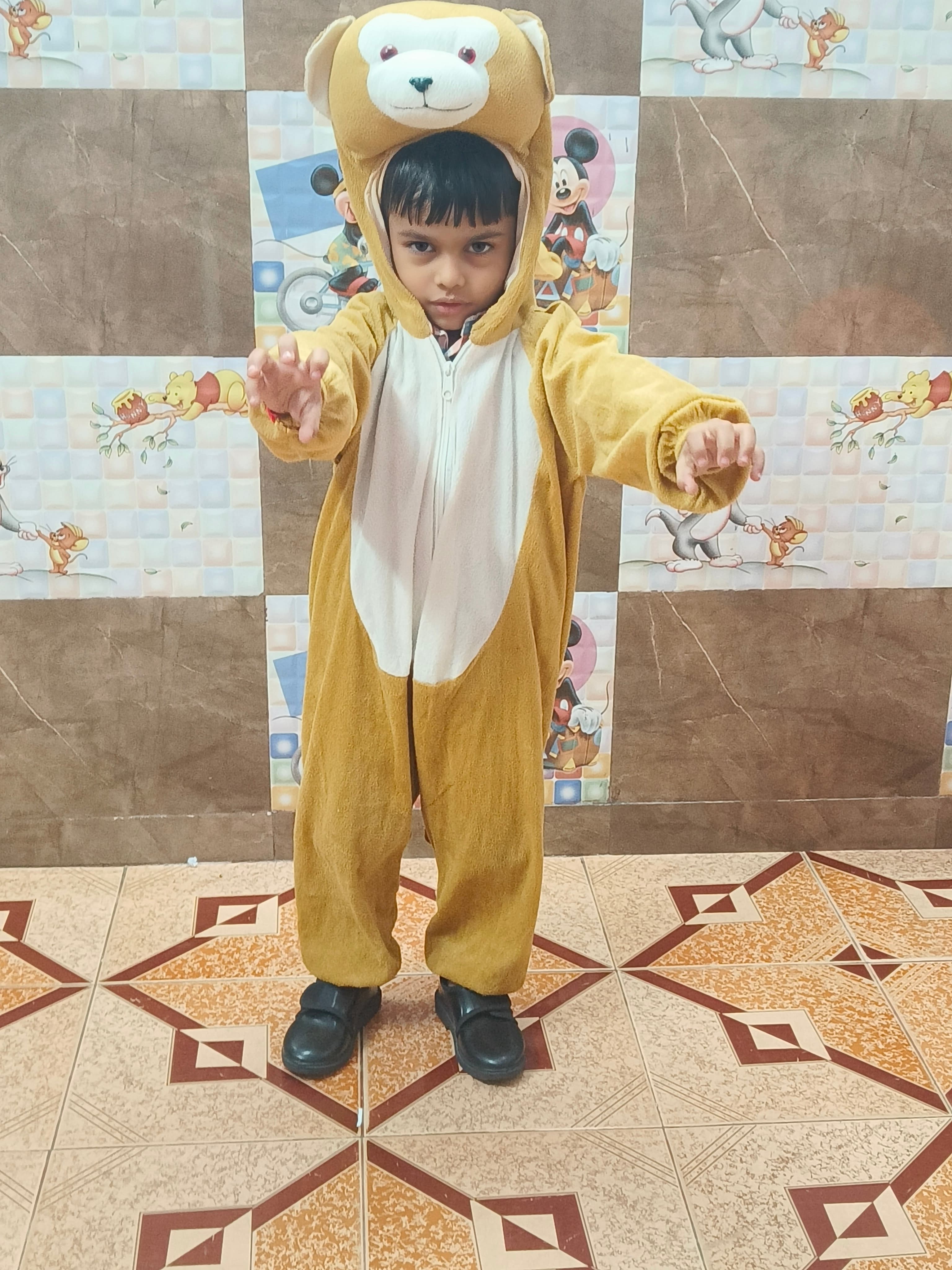 Boy in brown teddy bear costume making a roaring pose on Animal Day